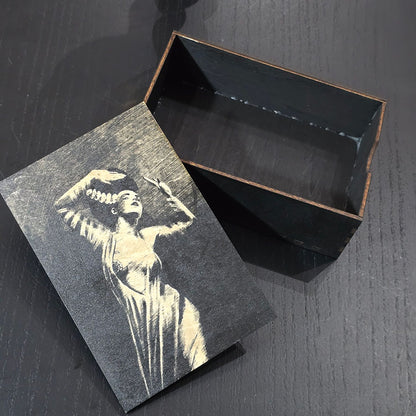Black wooden box with bride of Frankenstein engraved on a dark surface